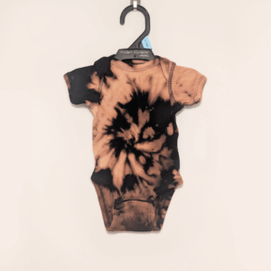 Black baby onesie with hand-bleached spiral design in the center
