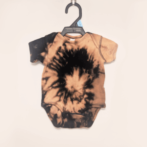 Black baby onesie with hand-bleached ringed design in the center