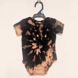 Black baby onesie with hand-bleached ringed design in the center