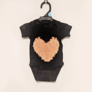 Black newborn onesie with hand-bleached heart design in the center