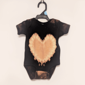 Black baby onesie with hand-bleached heart design in the center