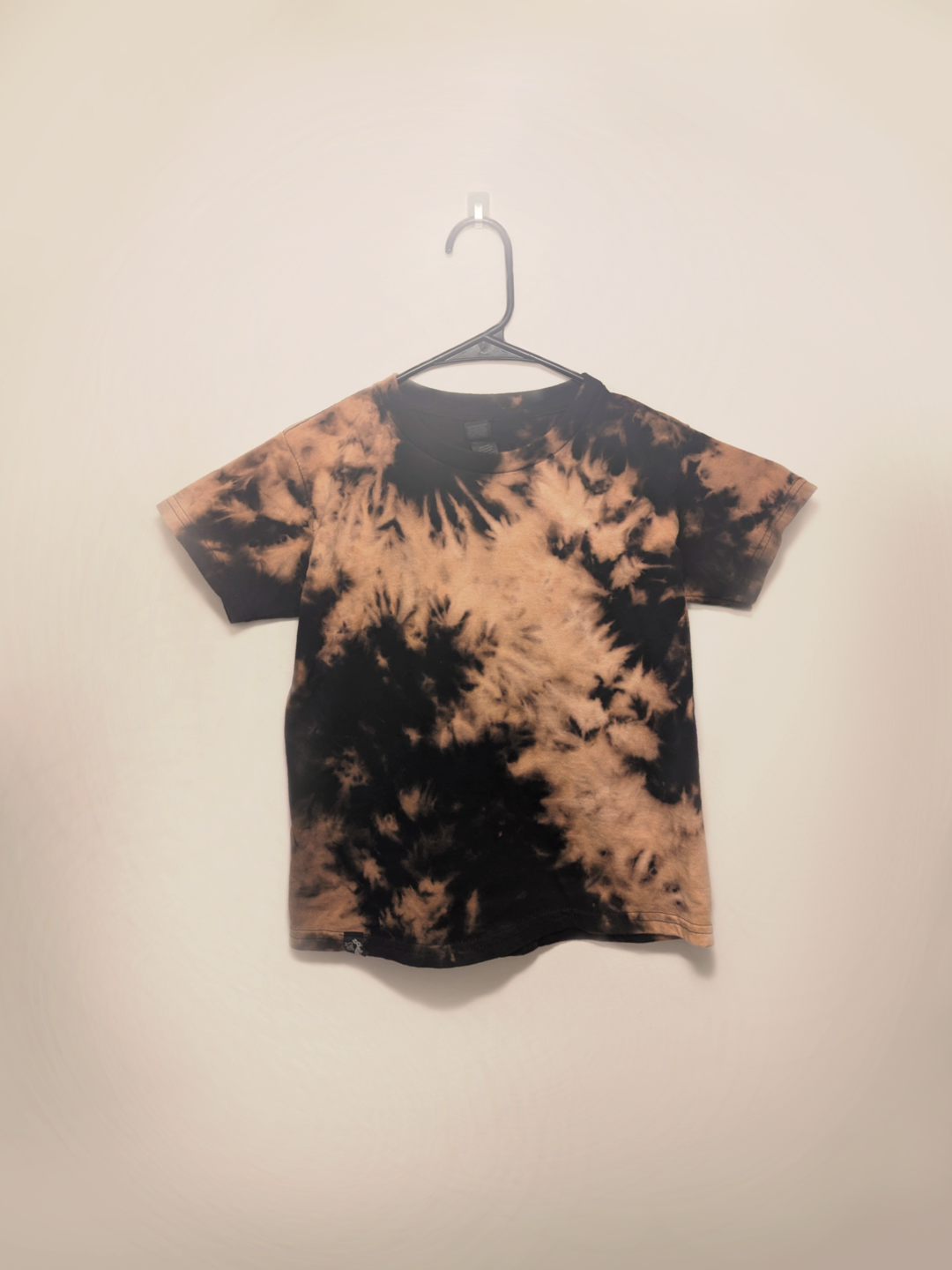 Black kids tee shirt with hand-bleached nebula design in the center
