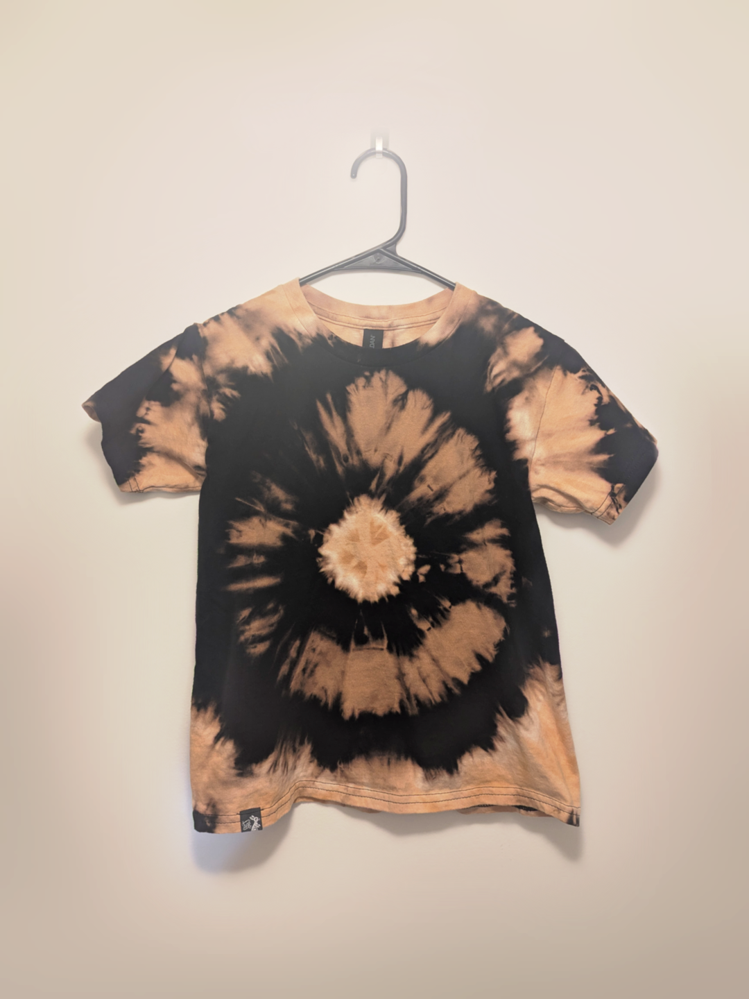 Black kids tee shirt with hand-bleached eye design in the center