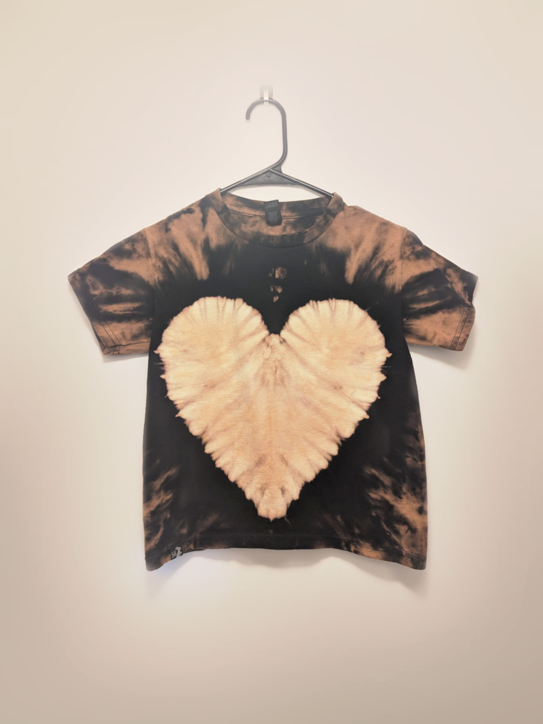 Black kids tee shirt with hand-bleached heart design in the center