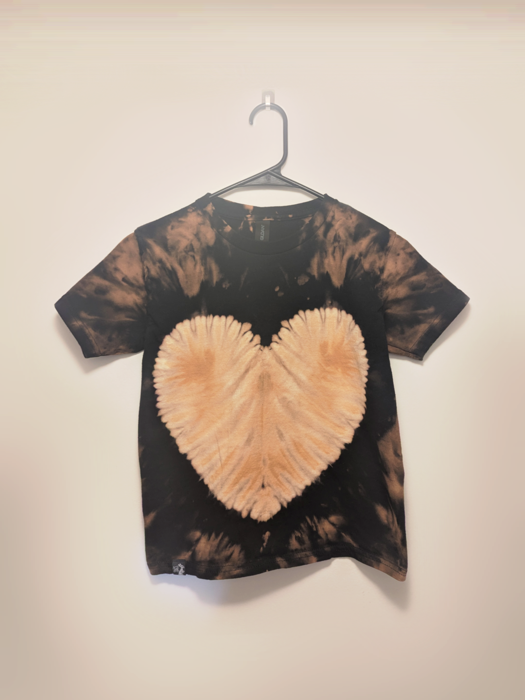 Black kids tee shirt with hand-bleached heart design in the center