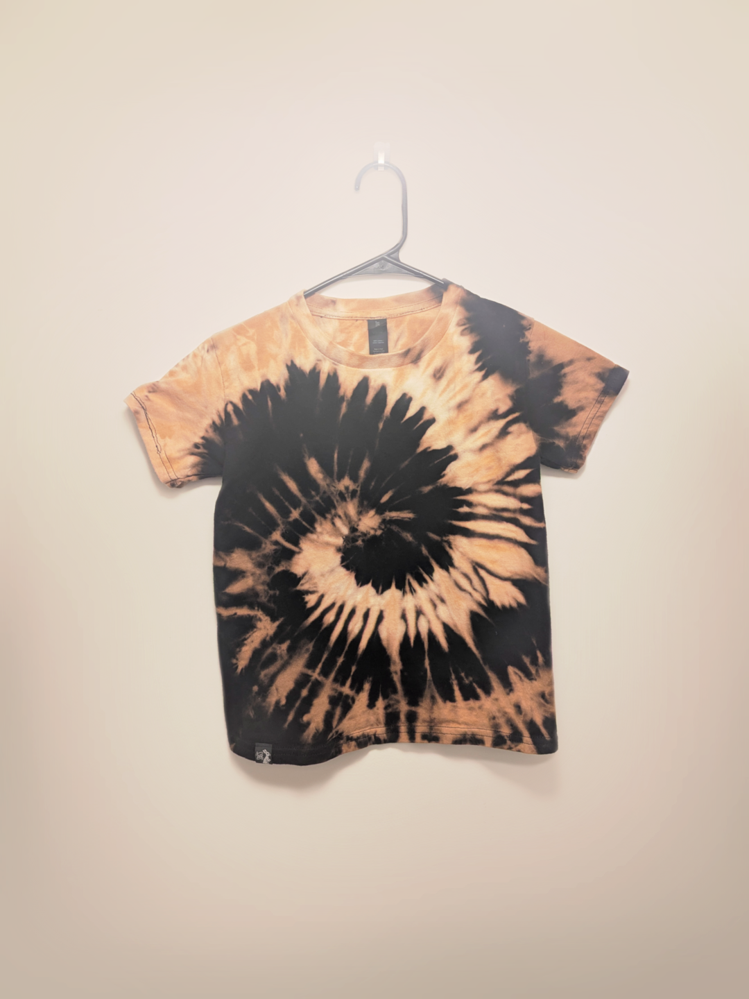 Black kids tee shirt with hand-bleached spiral design in the center