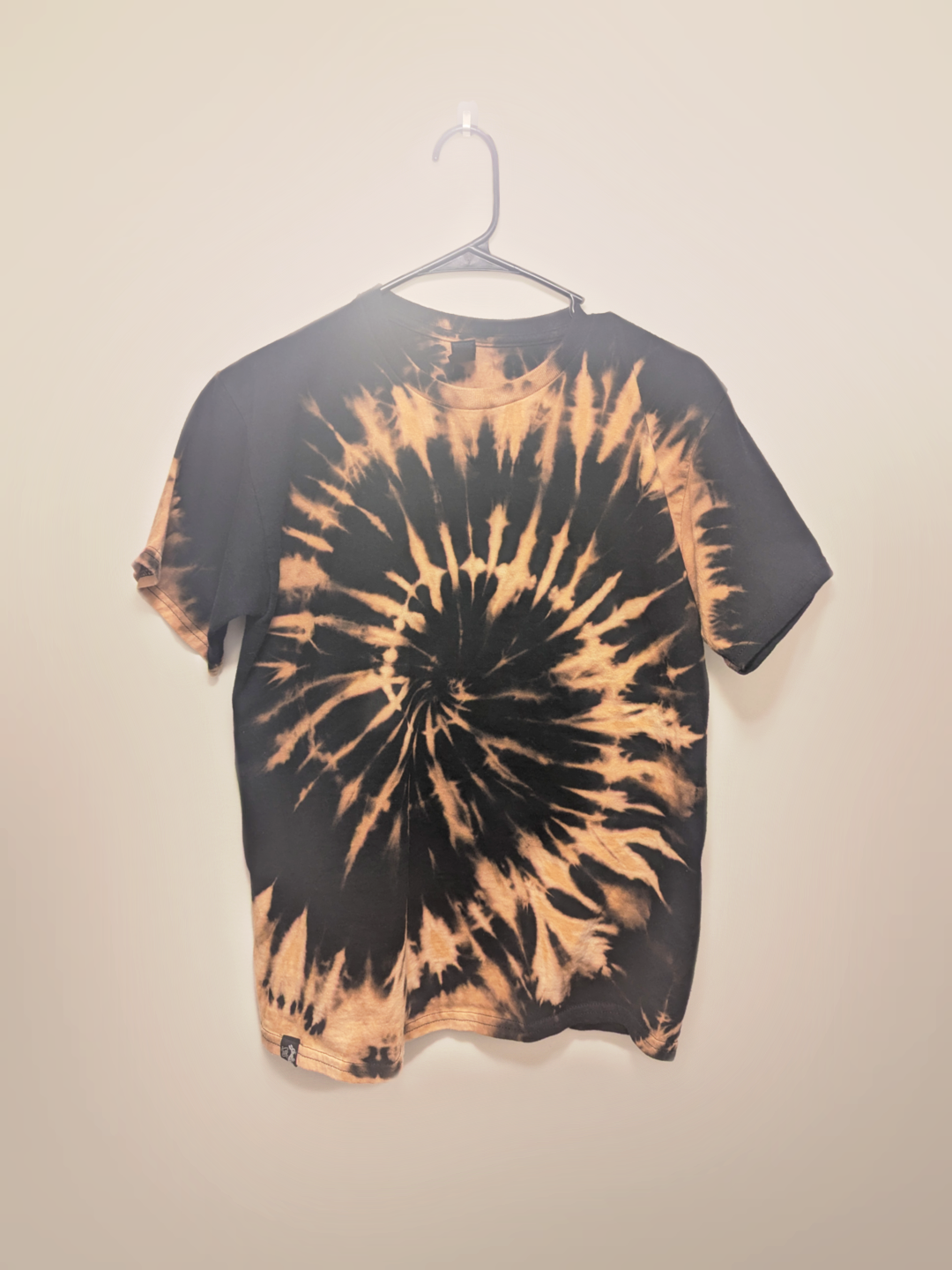 Black kids tee shirt with hand-bleached spiral design in the center