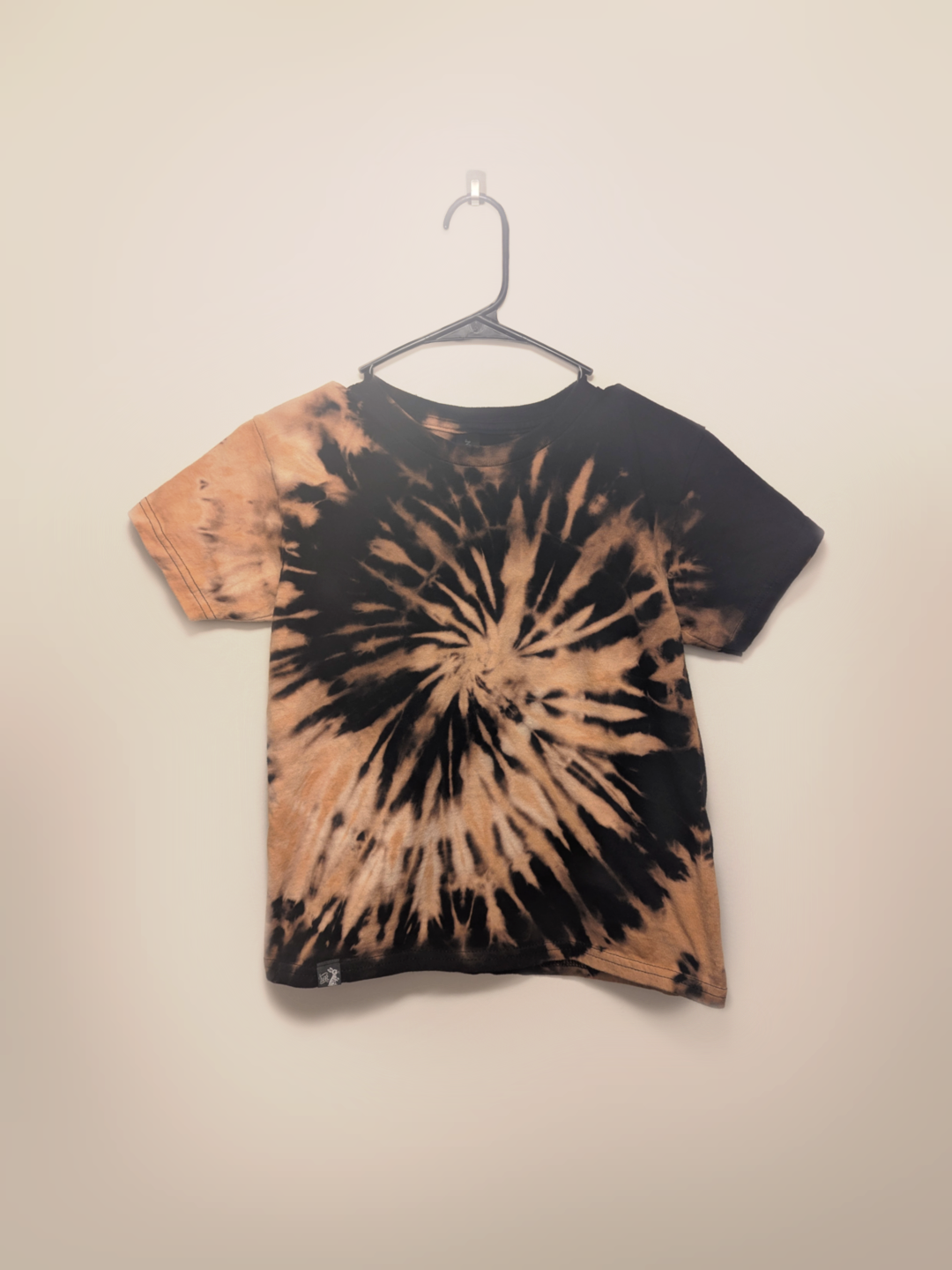 Black kids tee shirt with hand-bleached spiral design in the center