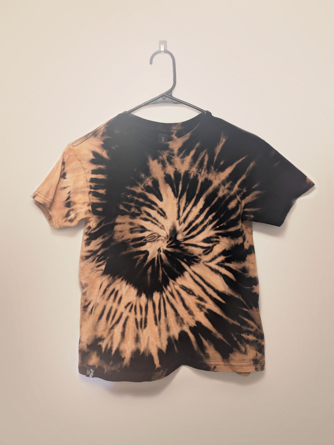 Black kids tee shirt with hand-bleached spiral design in the center