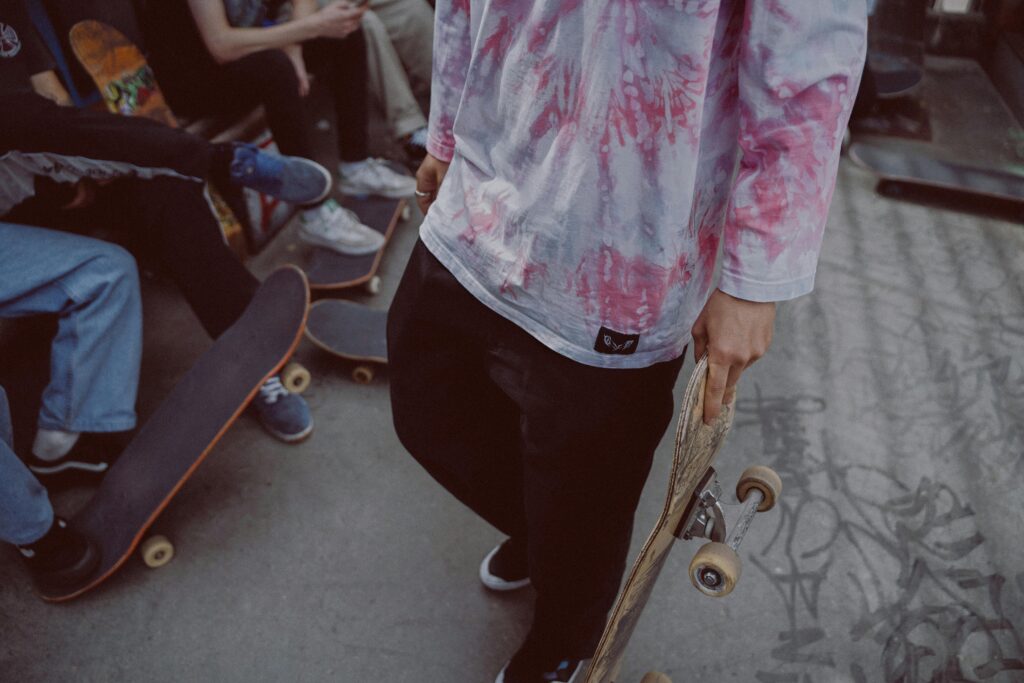 A group of skateboarders hanging out in the city, showcasing modern street style and skate culture.